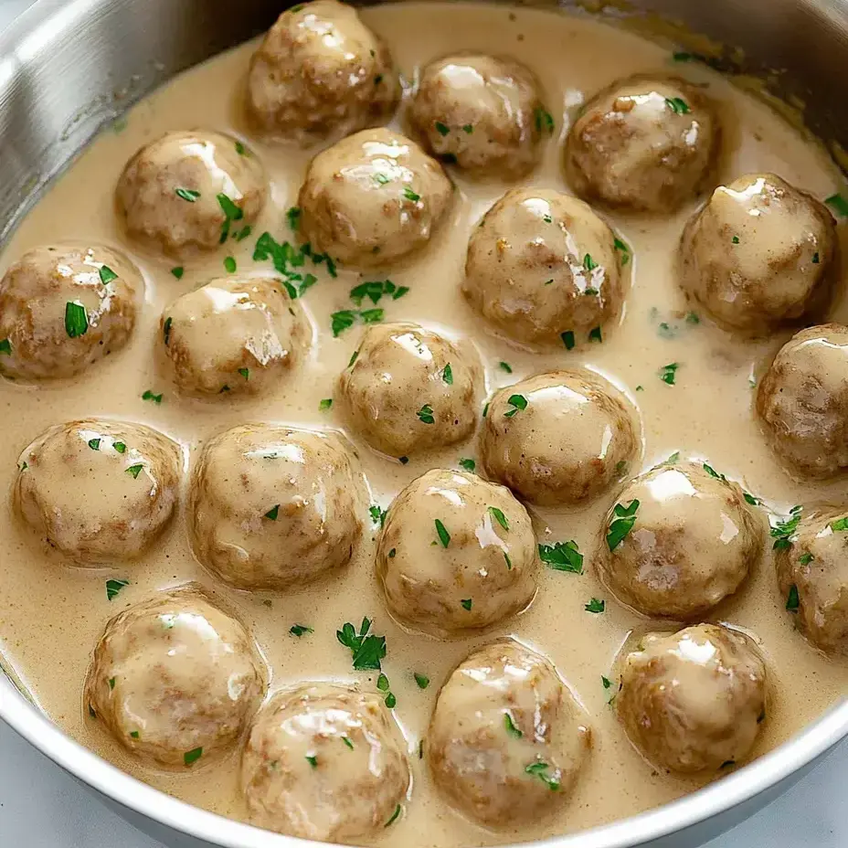 Eine Schüssel mit Fleischklößchen in cremiger Soße.